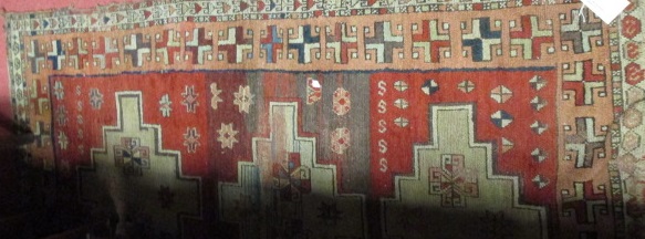 A Turkish rug on a red ground with three medallions, together with two other similar (3) - Image 2 of 2
