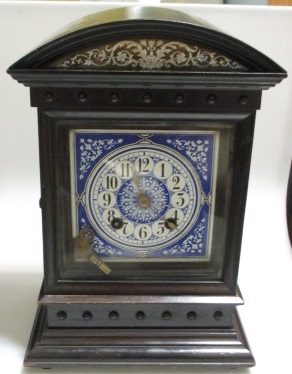 A clock with blue and white ceramic face