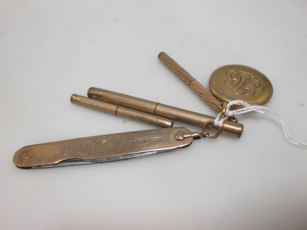 A Victorian locket, stamped 14k (9.3g), a 9ct gold penknife, London 1901and three unmarked yellow