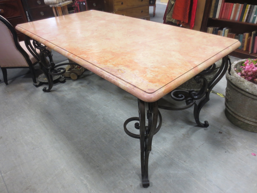 A marble topped table with decorative cast iron base. Height 73cm. Width 85cm. Length 159cm.