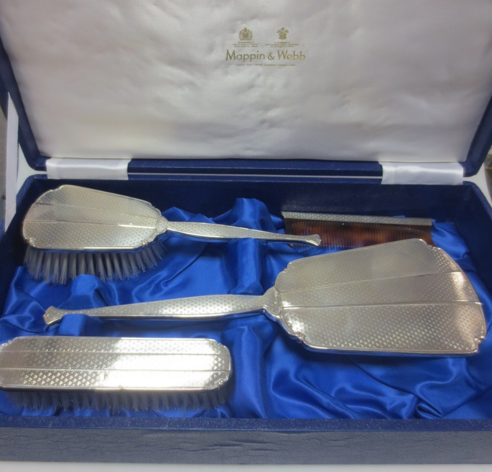 A silver backed dressing table set