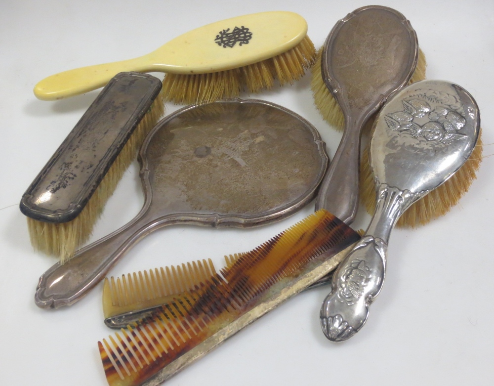 Six silver backed dressing table implements