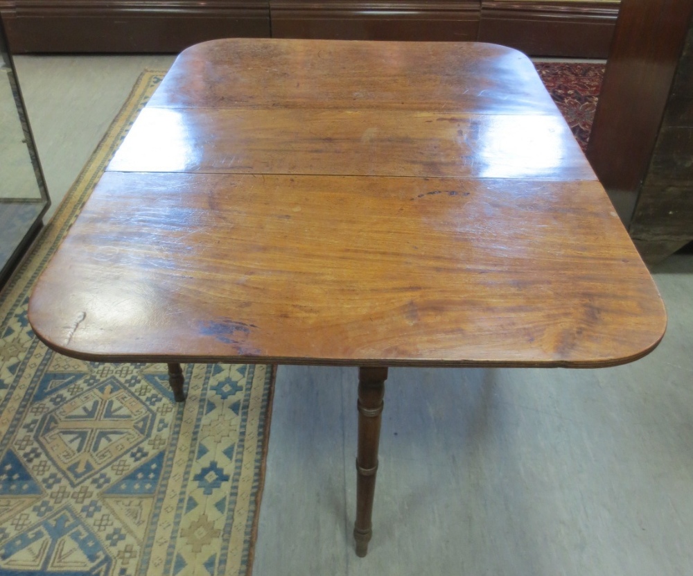 A 19th century mahogany drop leaf dining table. Height 69cm. Width 106cm. Length 140cm (leaf up)