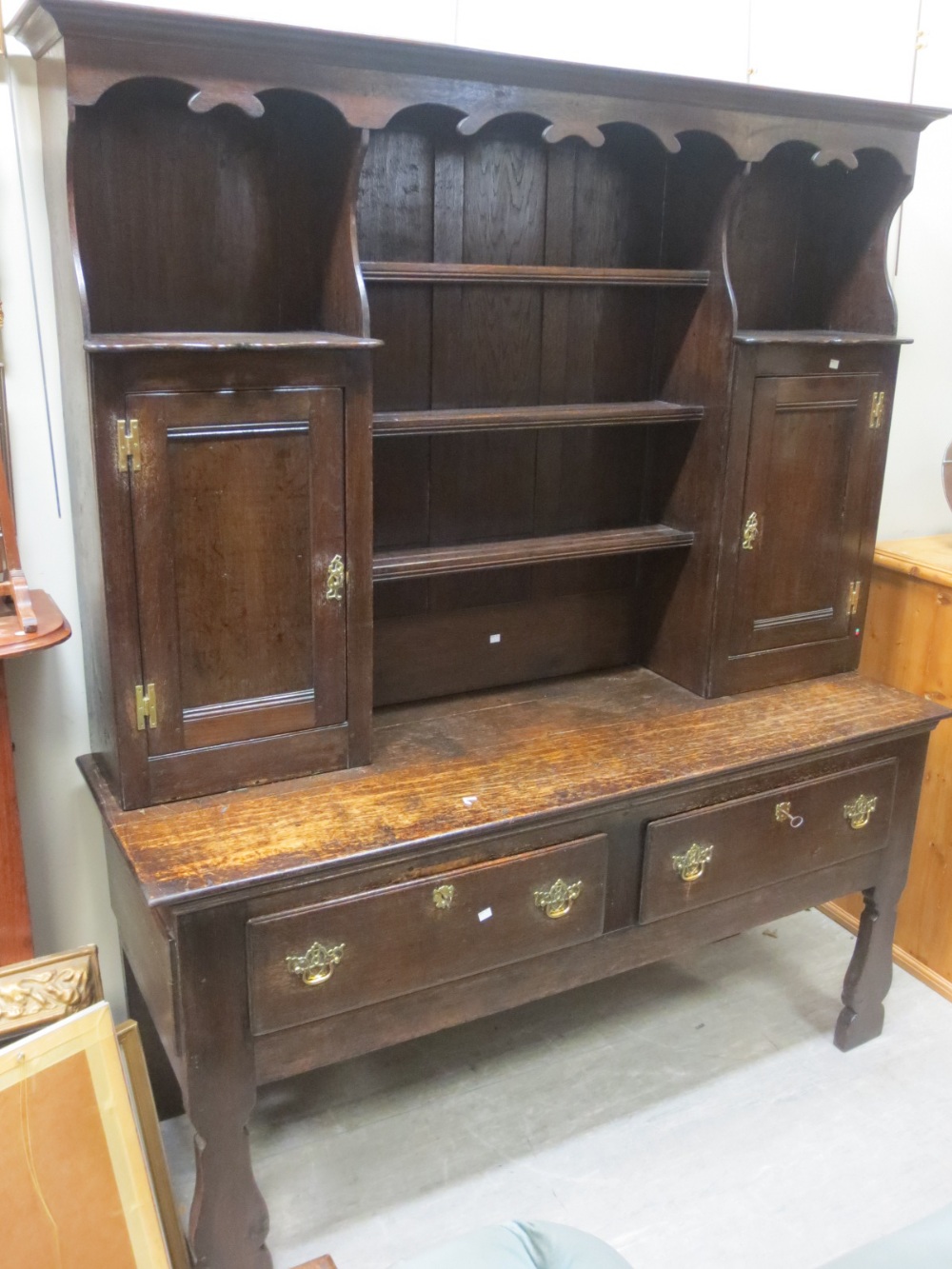 An oak dresser with open shelf back, basically 19th century. Height 205cm. Width 172cm. Depth 55cm.