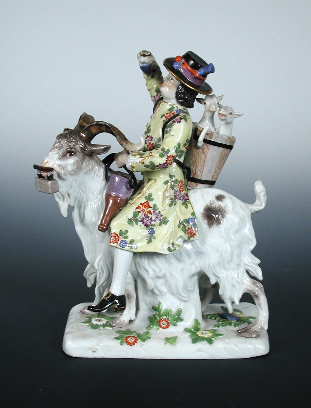 A 20th century Meissen figure of Count Bruhl`s tailor, he rides a goat with an iron in its mouth,