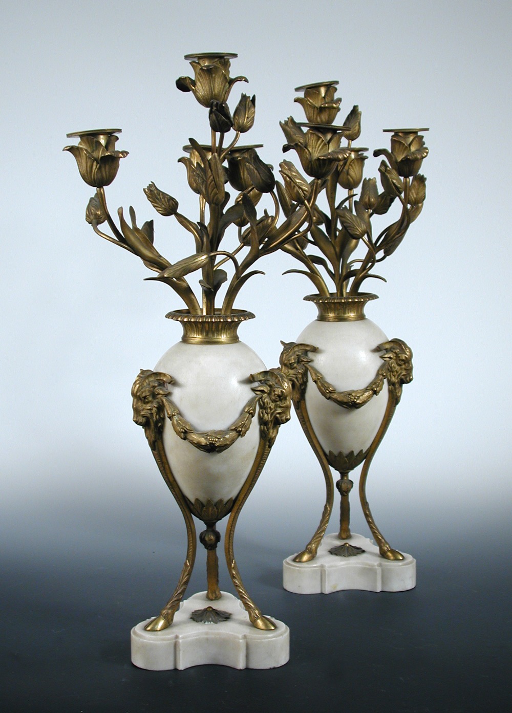 A pair of 19th century ormolu mounted white marble candelabra, each with four tulip nozzles raised