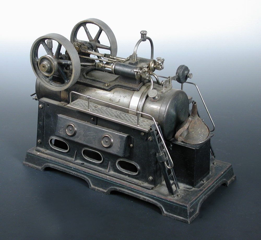 An early 20th century German model live steam engine, the tinplate chimney to one end of the