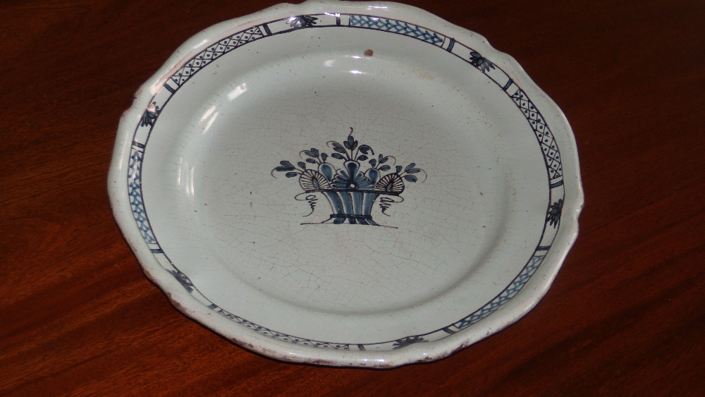 An 18th century faience charger, possibly northern French, painted in blue and manganese with the