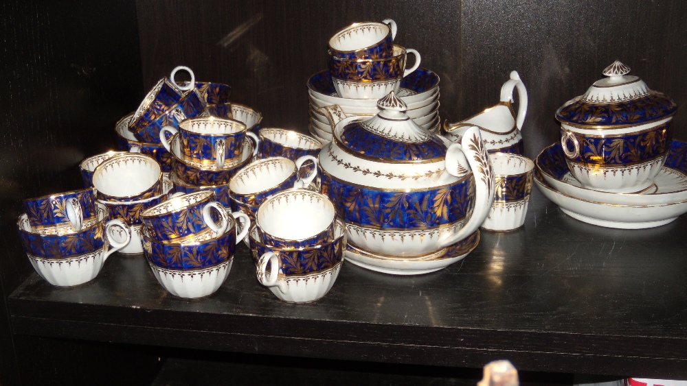 Attributed to Chamberlain`s Worcester, a blue and gilt tea and coffee service, each fluted piece