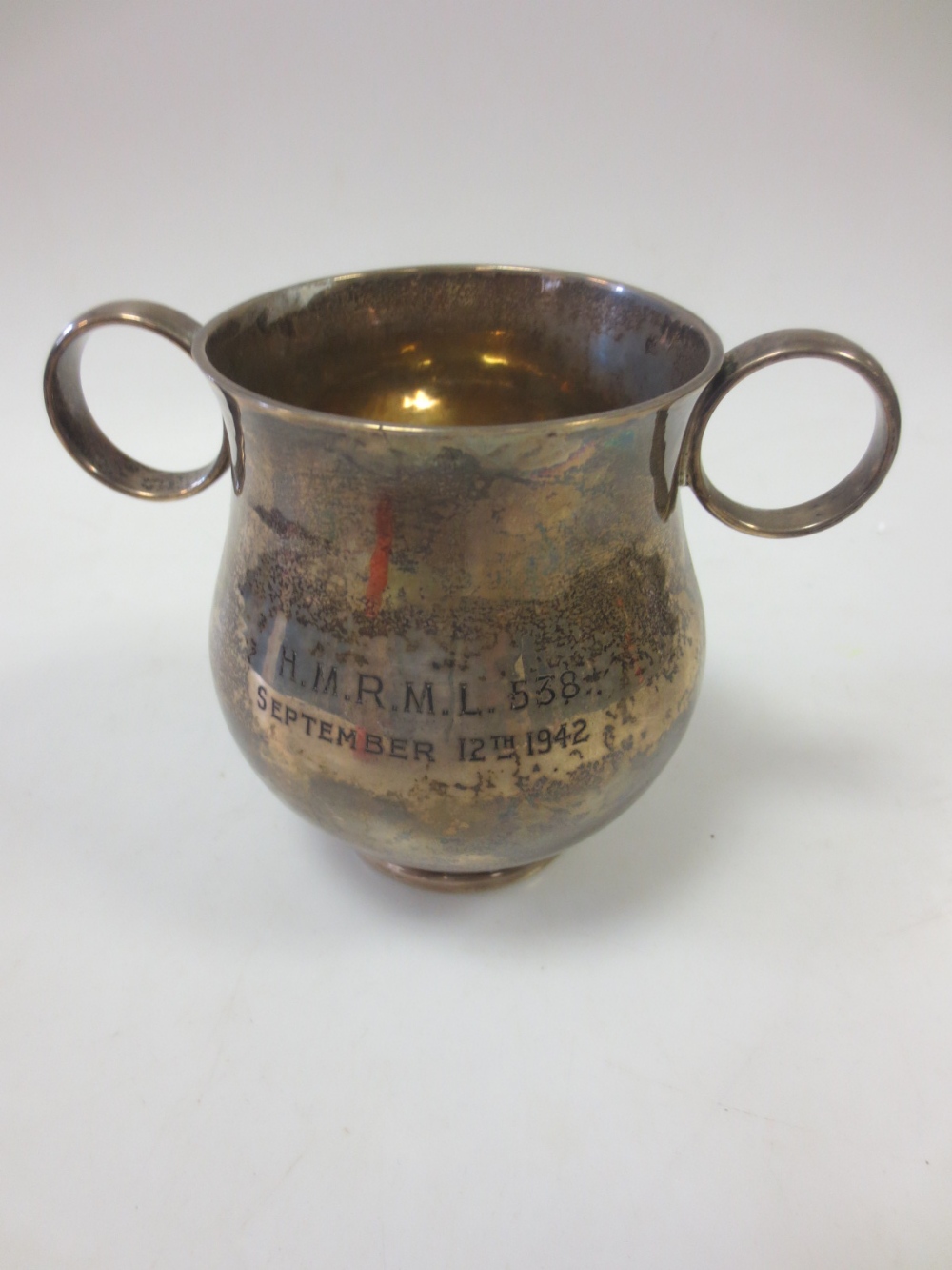 A silver trophy cup with two handles