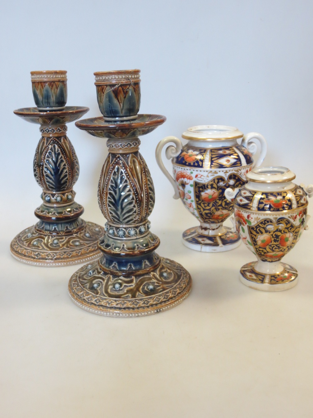 A pair of Doulton stoneware candlesticks and two Derby Imari jars (a/f) (4)