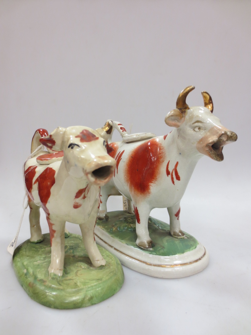 Two Staffordshire brown and white cow creamers