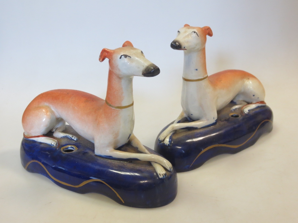 A pair of Staffordshire greyhound inkwells