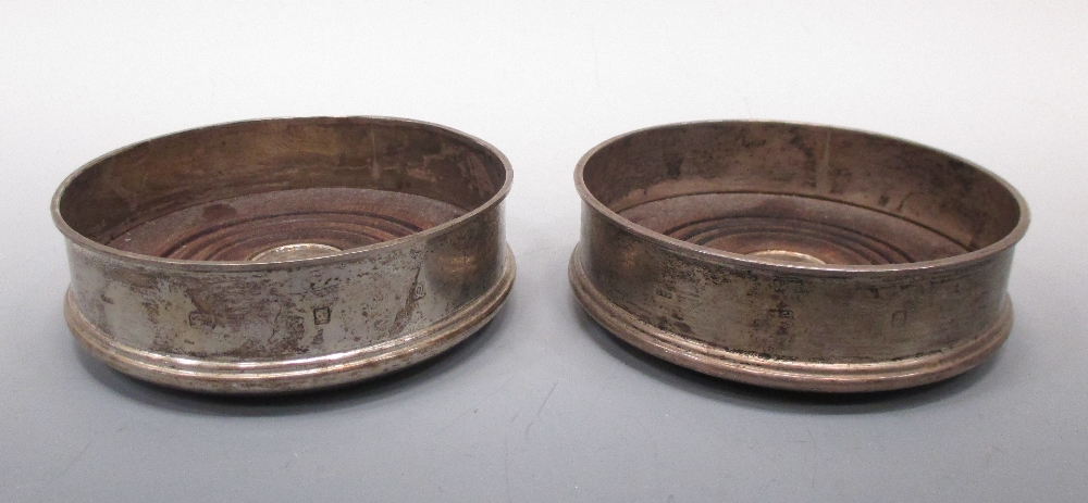 A pair of modern silver wine coasters by David Mills, London 1990