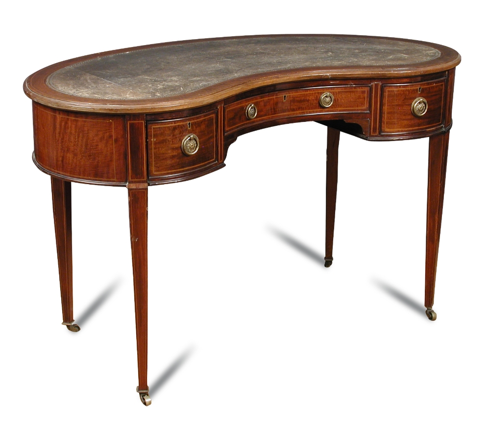 An Edwardian mahogany kidney shaped writing table, green leather lined top with boxwood line inlaid