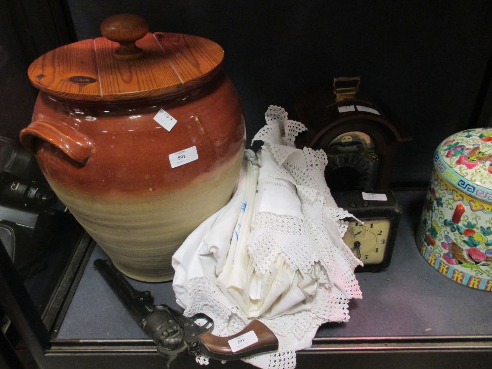 A replica colt type revolver, a modern mantel clock, a crock pot, and a mantel clock