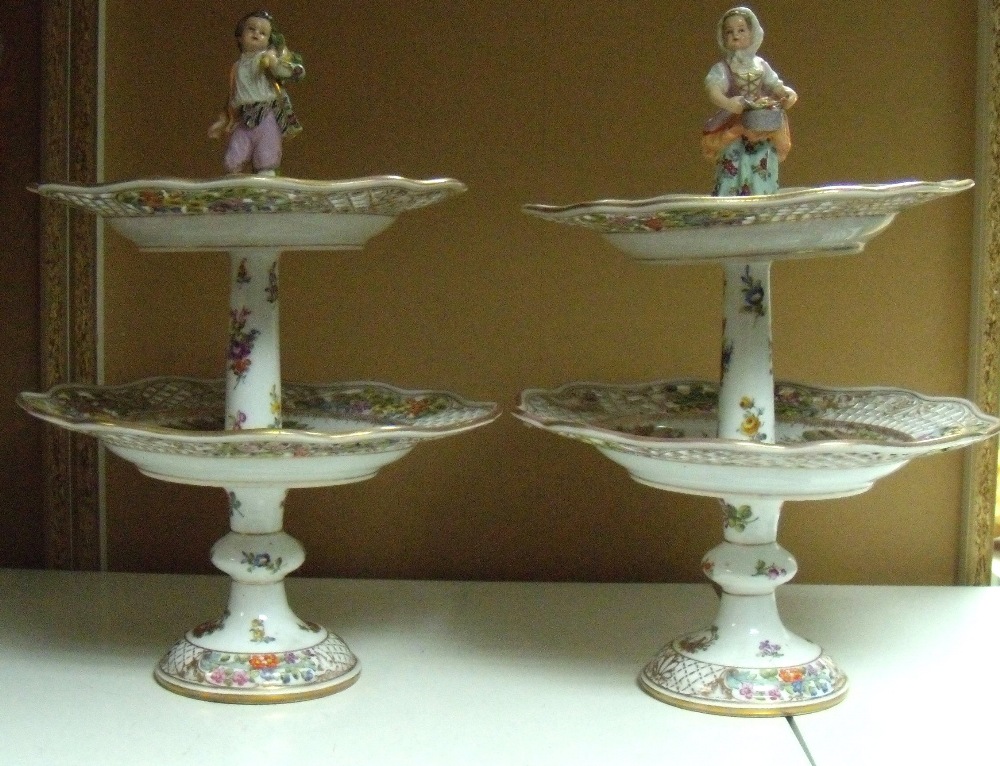 A pair of late 19th century Dresden two tier comports, each tier painted with three 18th century