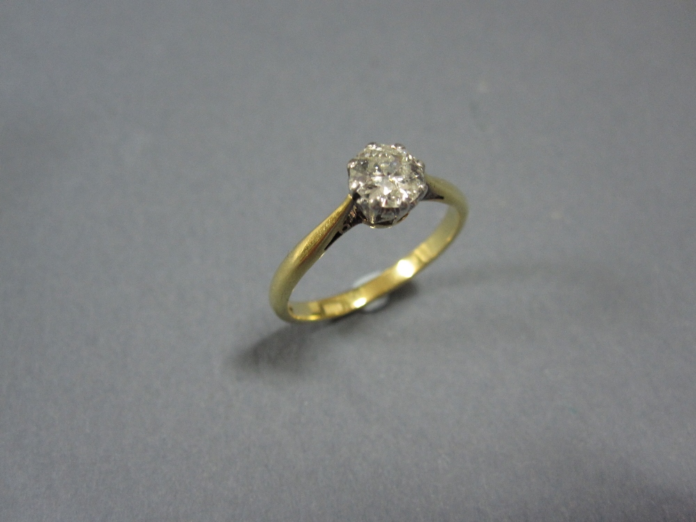 A single stone diamond ring, the old round brilliant cut diamond claw set with a heart motif