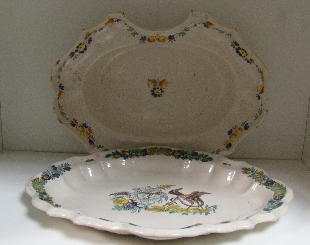 An 18th century French faience barber`s bowl and a dish, possibly Strasbourg, the former with the