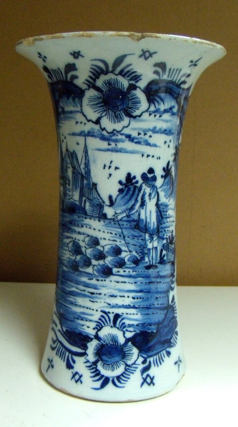 A mid 18th century Delft blue and white vase, the waisted cylindrical body painted on one side with