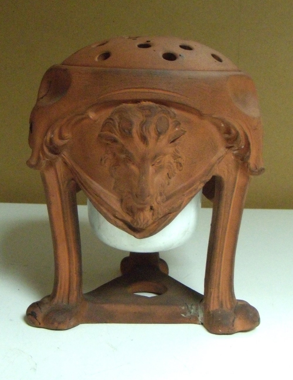 An early 19th century redware pot pourri vase and cover, together with a later porcelain liner, the