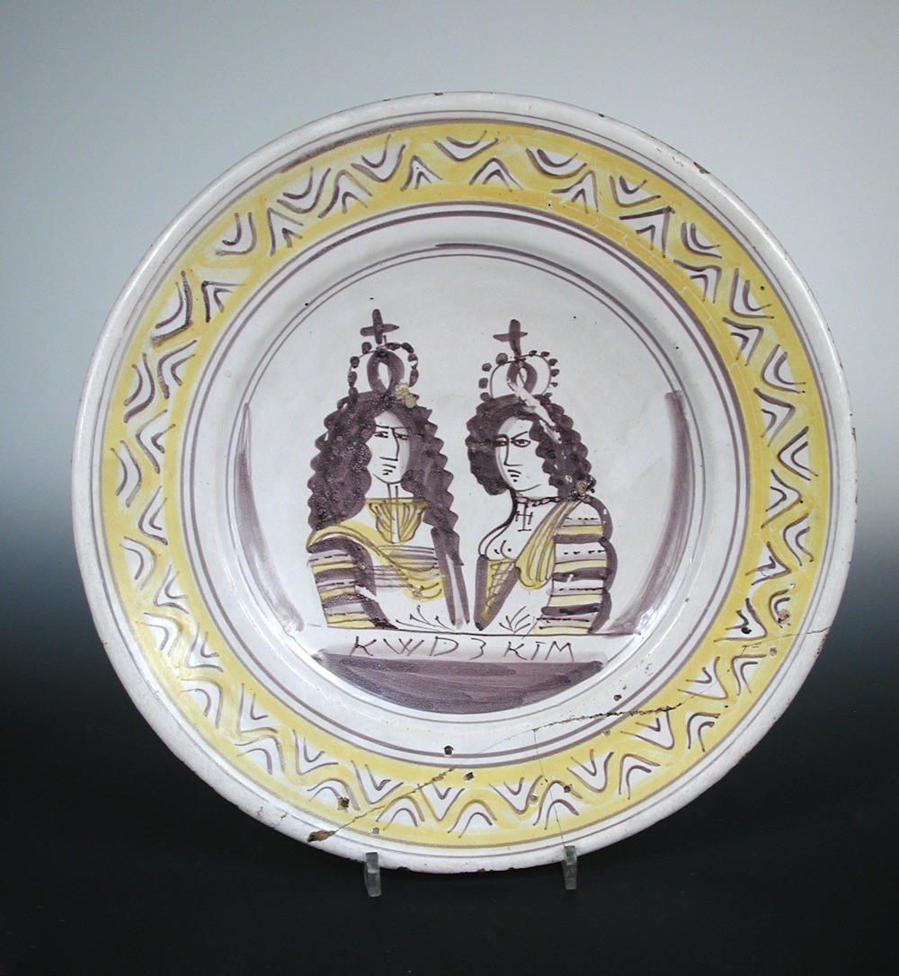 A late 17th century Delft coronation dish for King William and Queen Mary, the central manganese