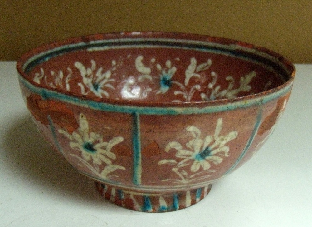 A terracotta ground bowl, possibly 18th century Kutahya, the interior painted in white slip and