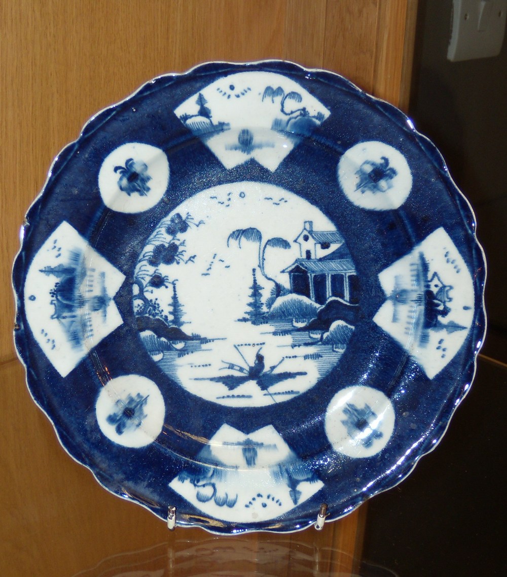 A Bow blue and white chinoiserie plate, alternating fan and roundels on the blue ground enclosing