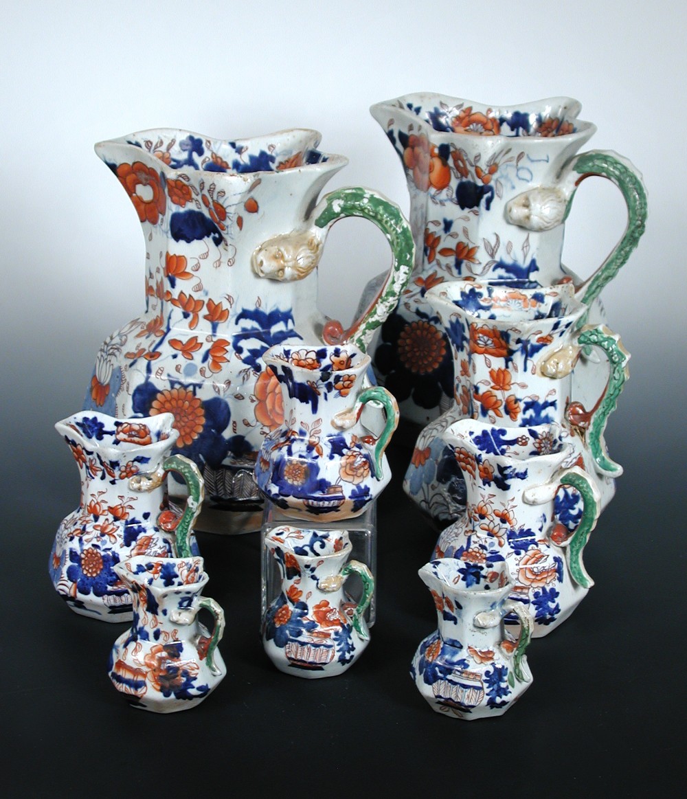A matched and graded set of nine Mason`s ironstone jugs, each of the octagonal shapes printed and