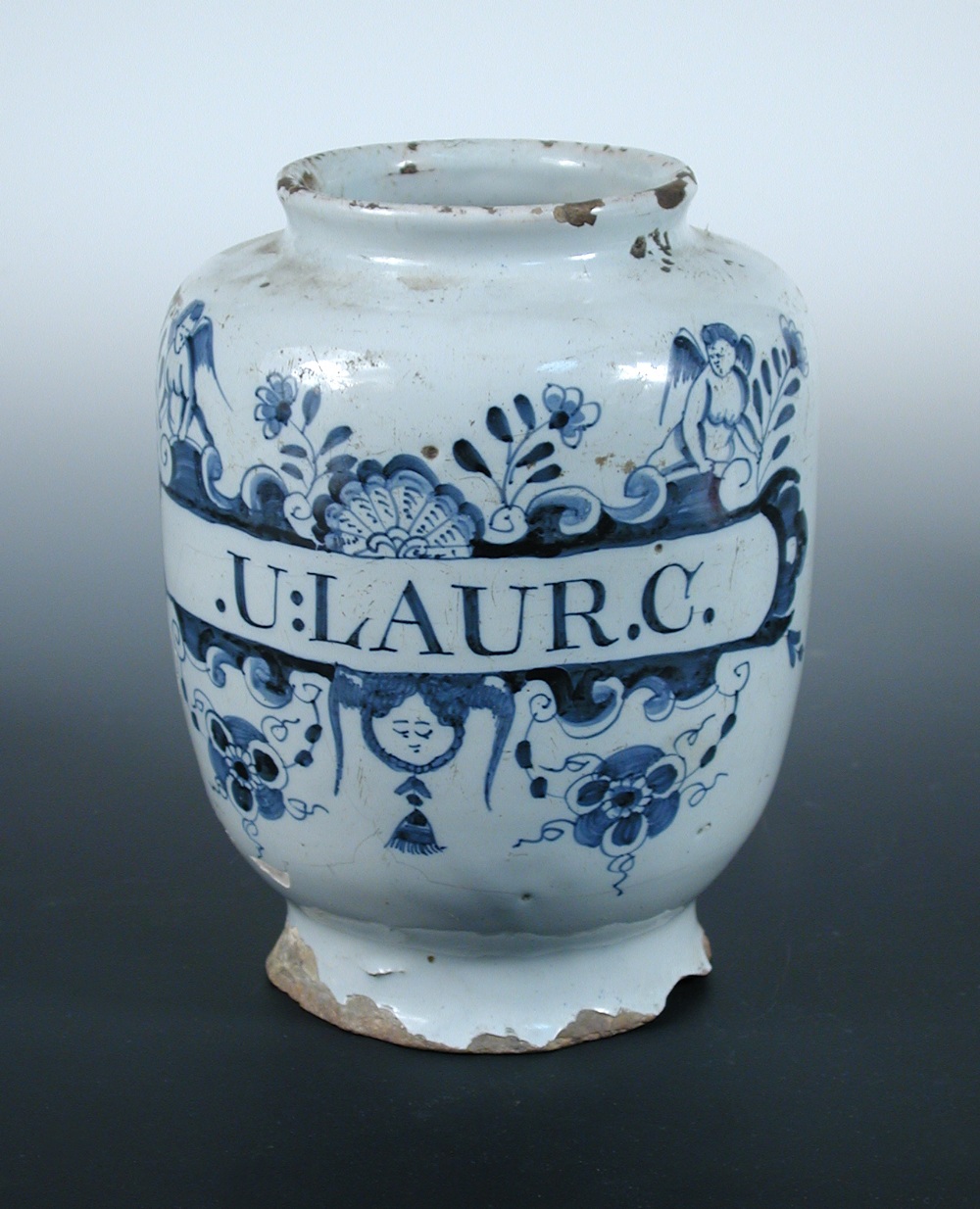 A mid 18th century English Delft blue and white drug jar, possibly London, painted with a cherub