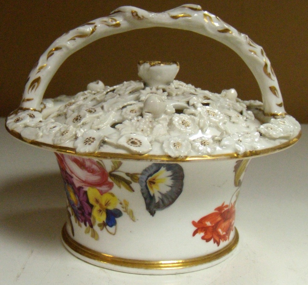 An early 19th century pot pourri basket and cover, possibly Coalport, the rustic handle ending in