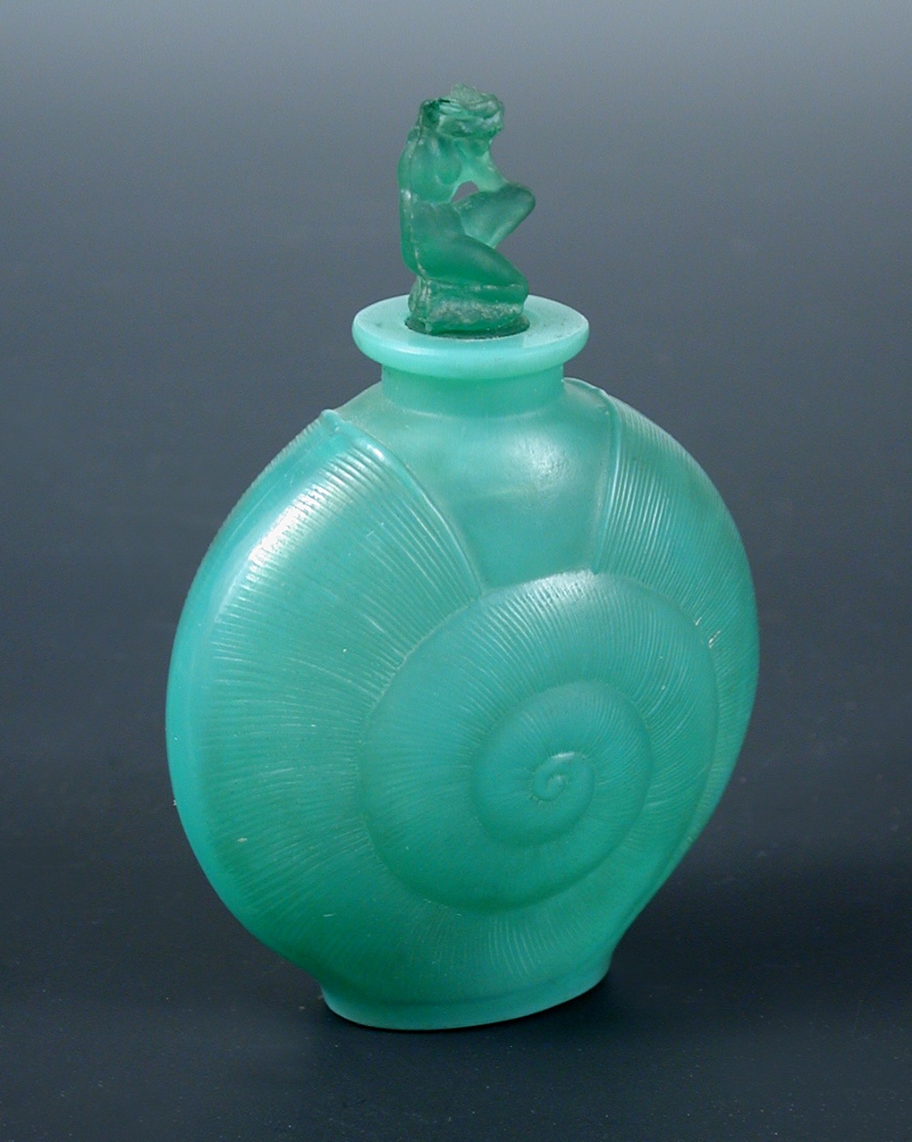 René Lalique, an Amphitrite pattern green glass scent bottle and stopper, the shell-form bottle in