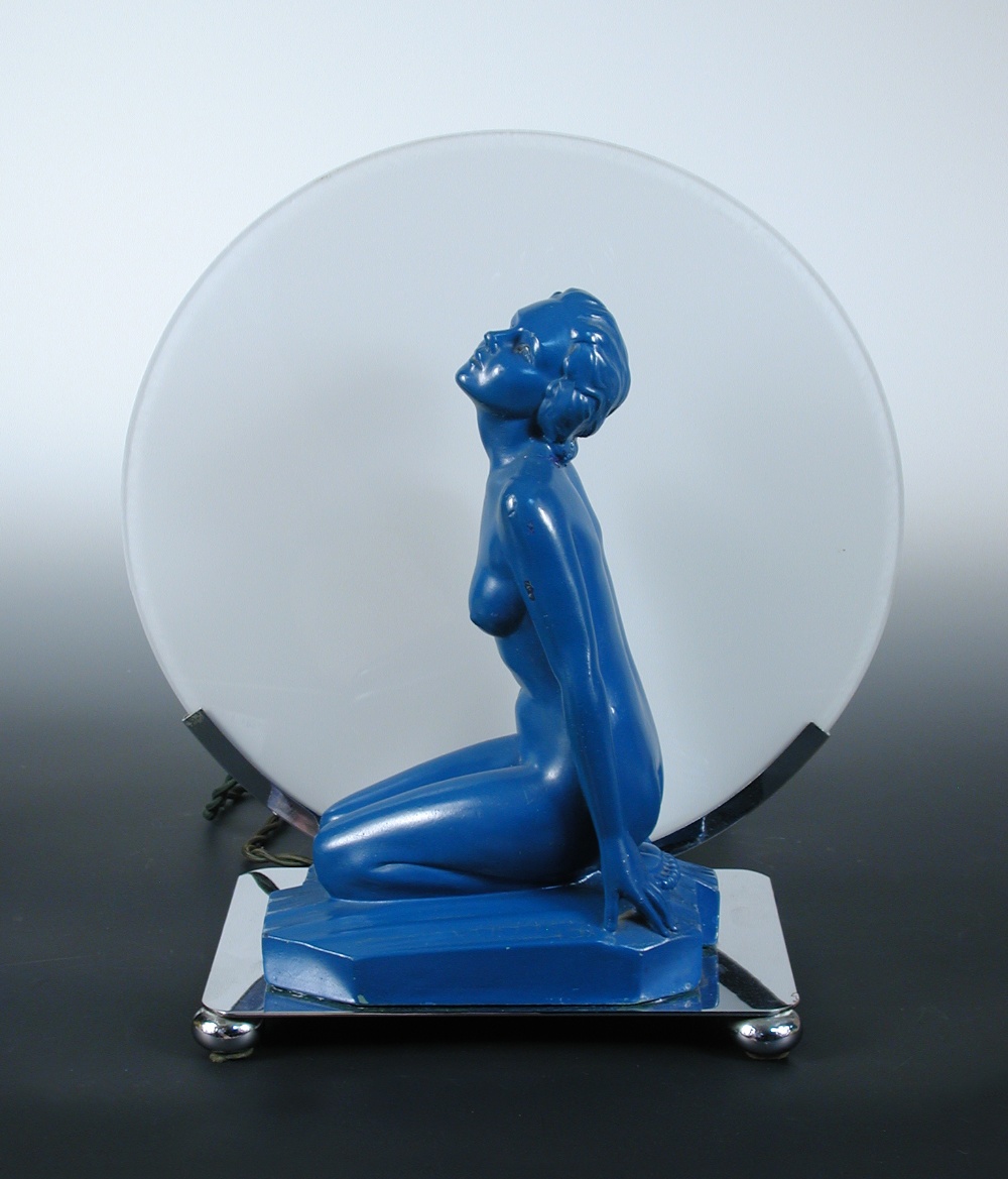 An Art Deco figural lamp, with a blue painted plaster model of a kneeling female nude in front of an