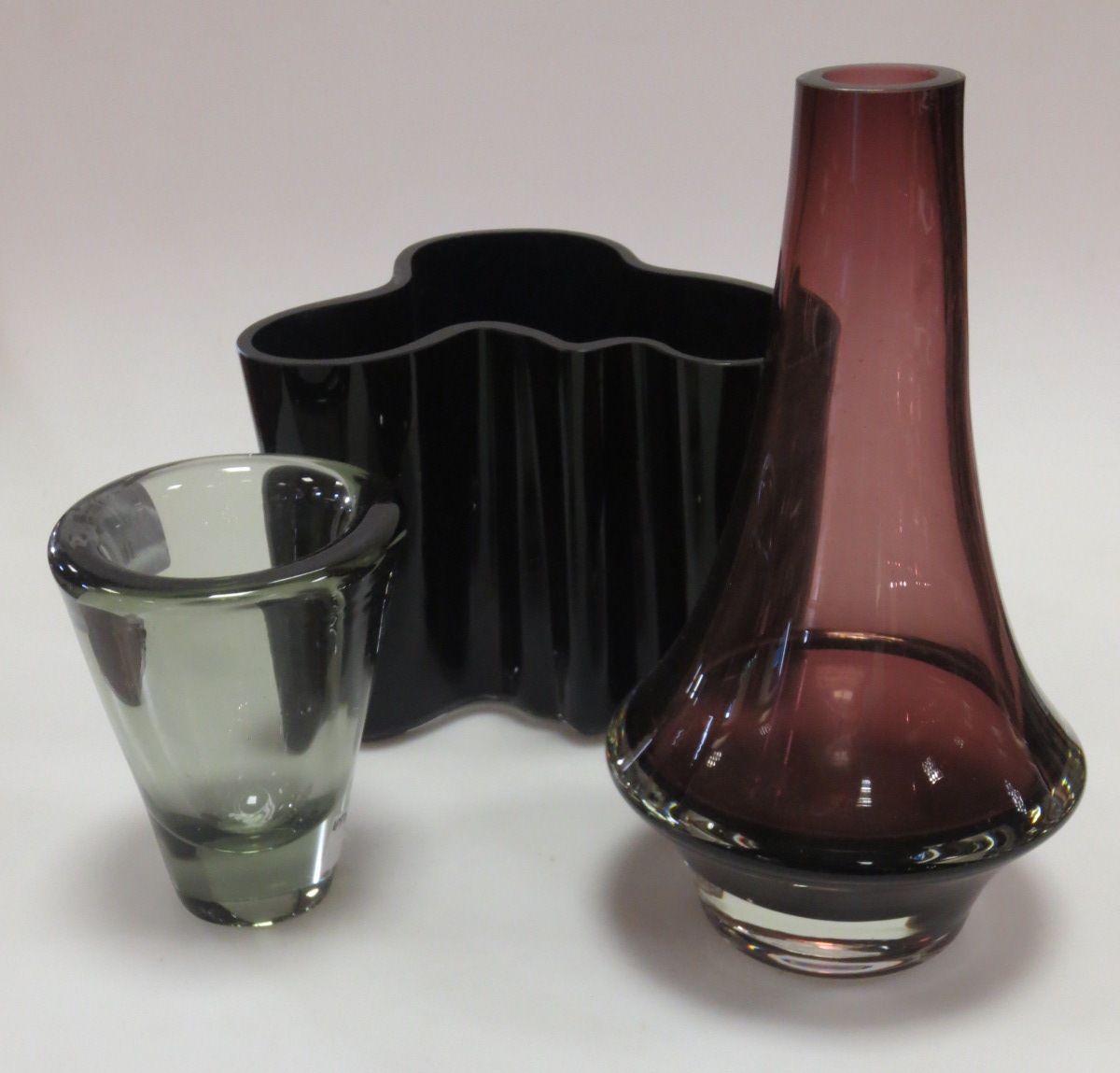 An Alvar Aalto deep blue `Savoy` vase, a plum coloured bottle vase by Riihimaki Lasi and a smoked