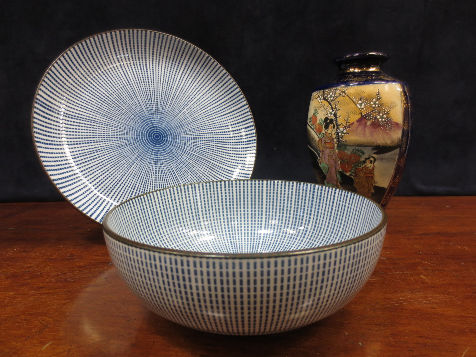 A Japanese Fukagawa flask with a blue dragon and gold clouds, a Japanese octagonal Imari plate, a