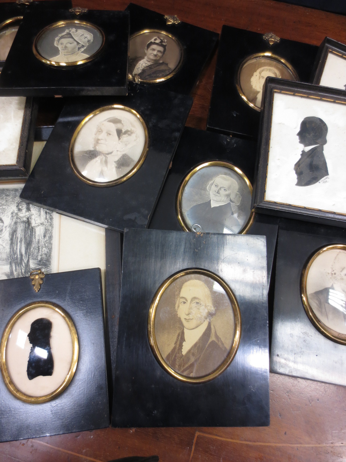 Eight ebony framed photographs, a silhouette, three others and a print