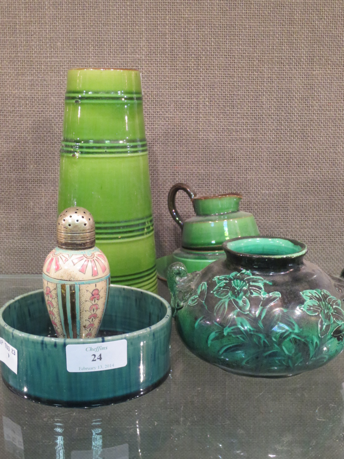 A Linthorpe pepper, a cylindrical bowl, four Torquay green wares and a green floral vase