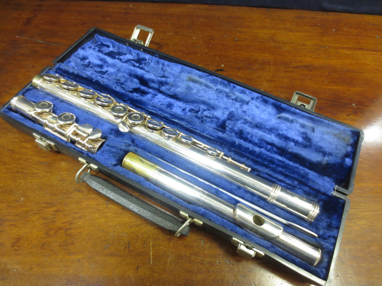 A silver coloured flute `Germeinhardt` in case