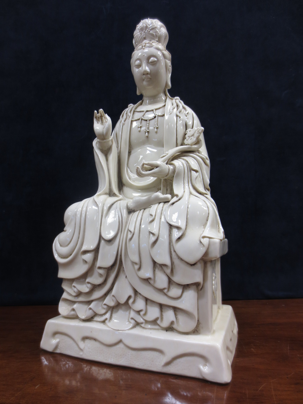 A blanc de Chine figure of Guanyin enthroned