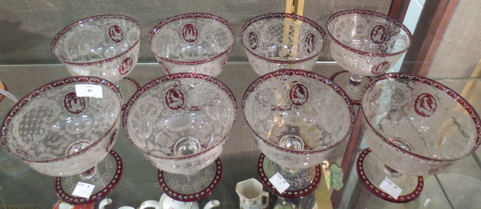 Eight Bohemian etched coloured glass stem bowls