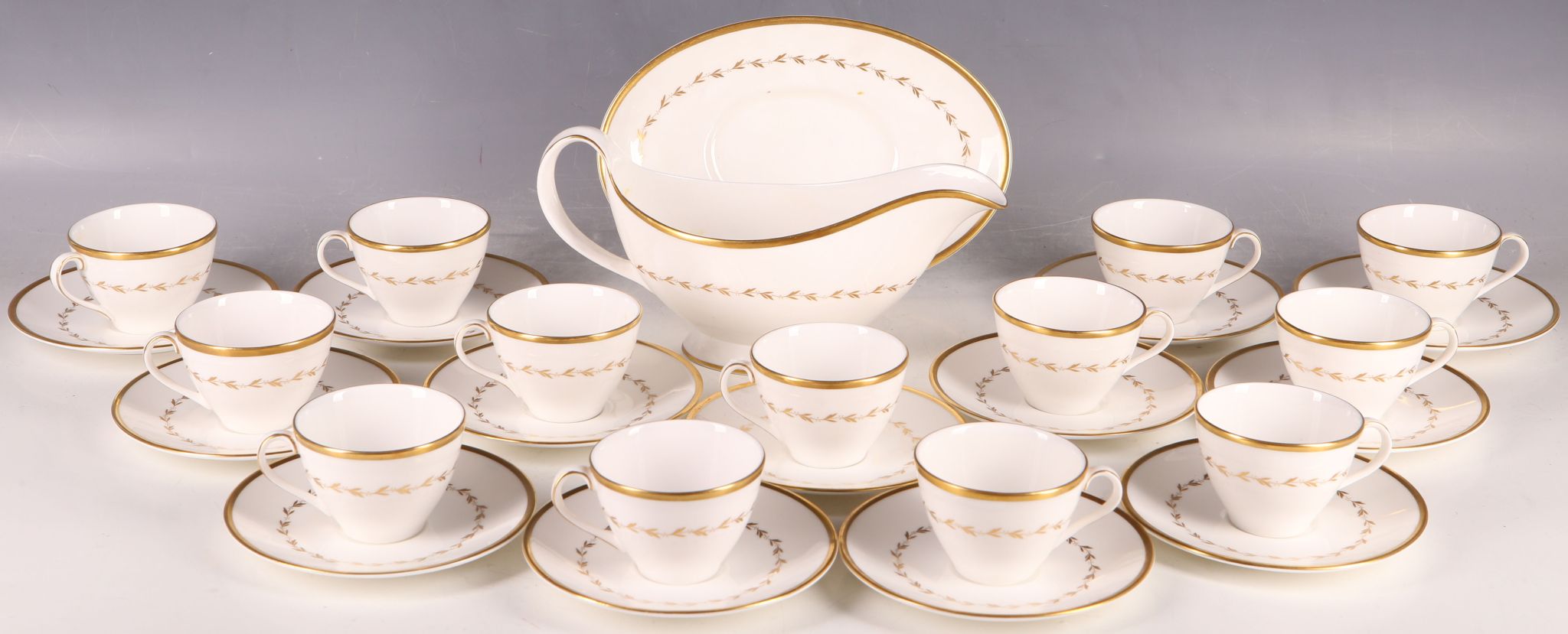 A Royal Doulton `Covington` pattern sauce / gravy boat and saucer and twelve demi-fuse cups and