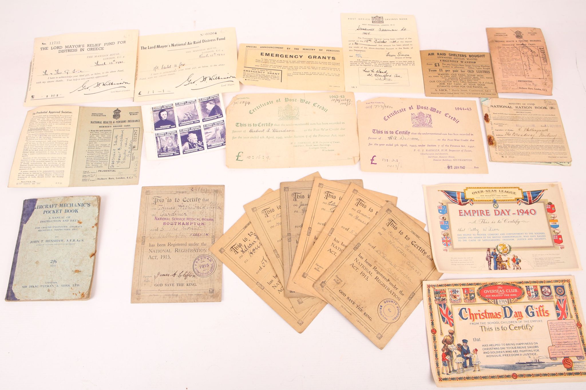 A selection of identity cards, certificates and other war time ephemera.