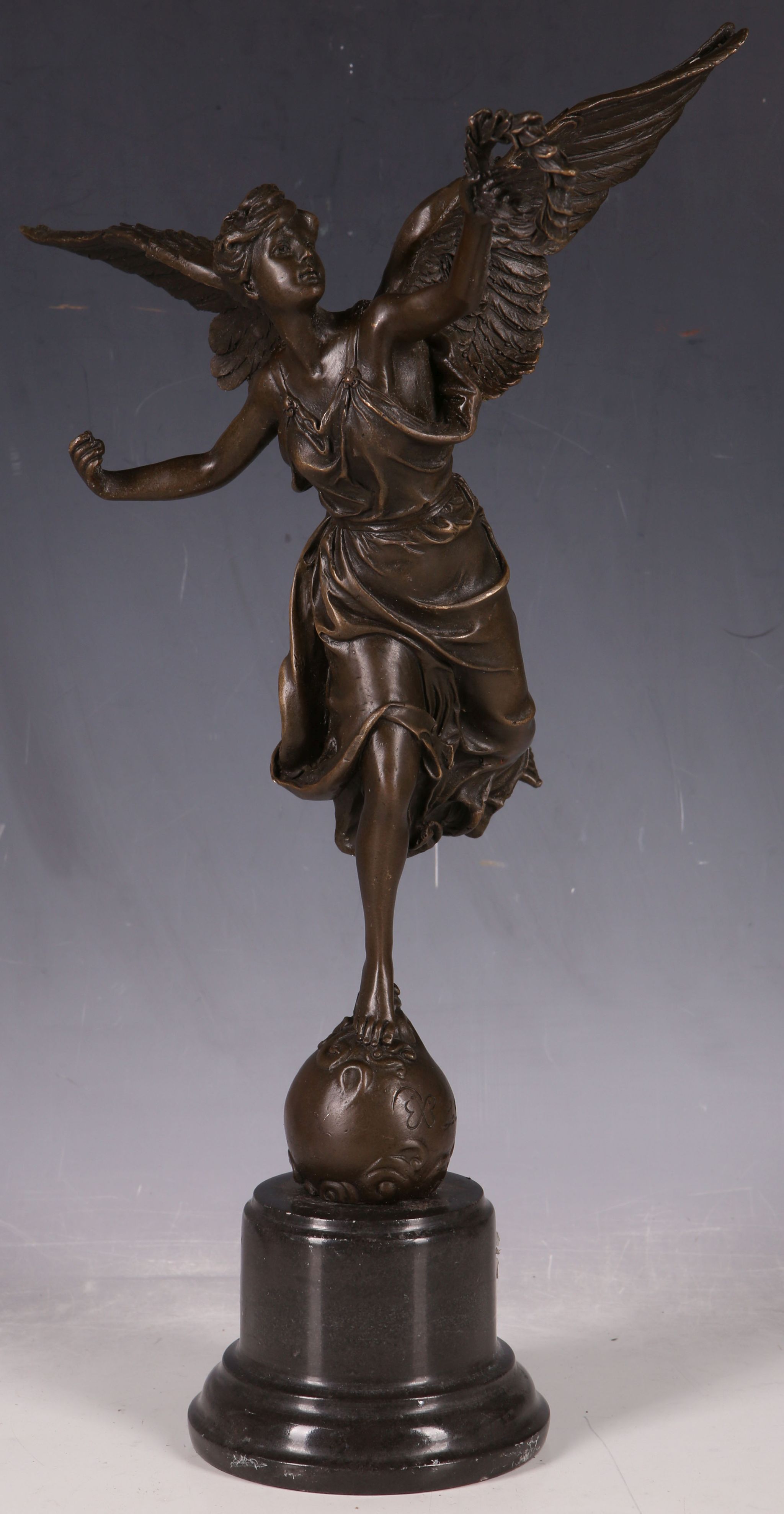 A bronzed statue after Ernest Barrias study of angel holding laurel garland atop a ball, approx.