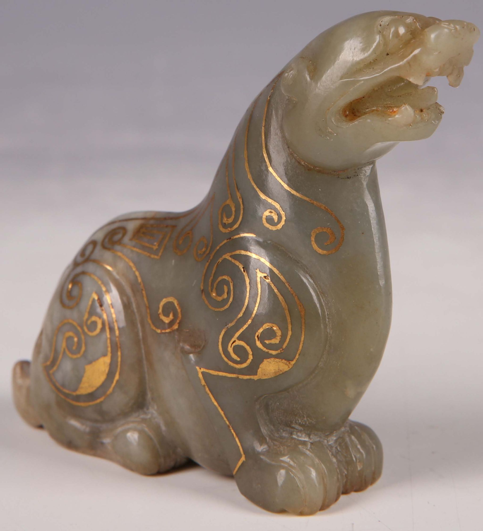 A Chinese jade mythical beast, with gold inlaid design, 6.5cm H.