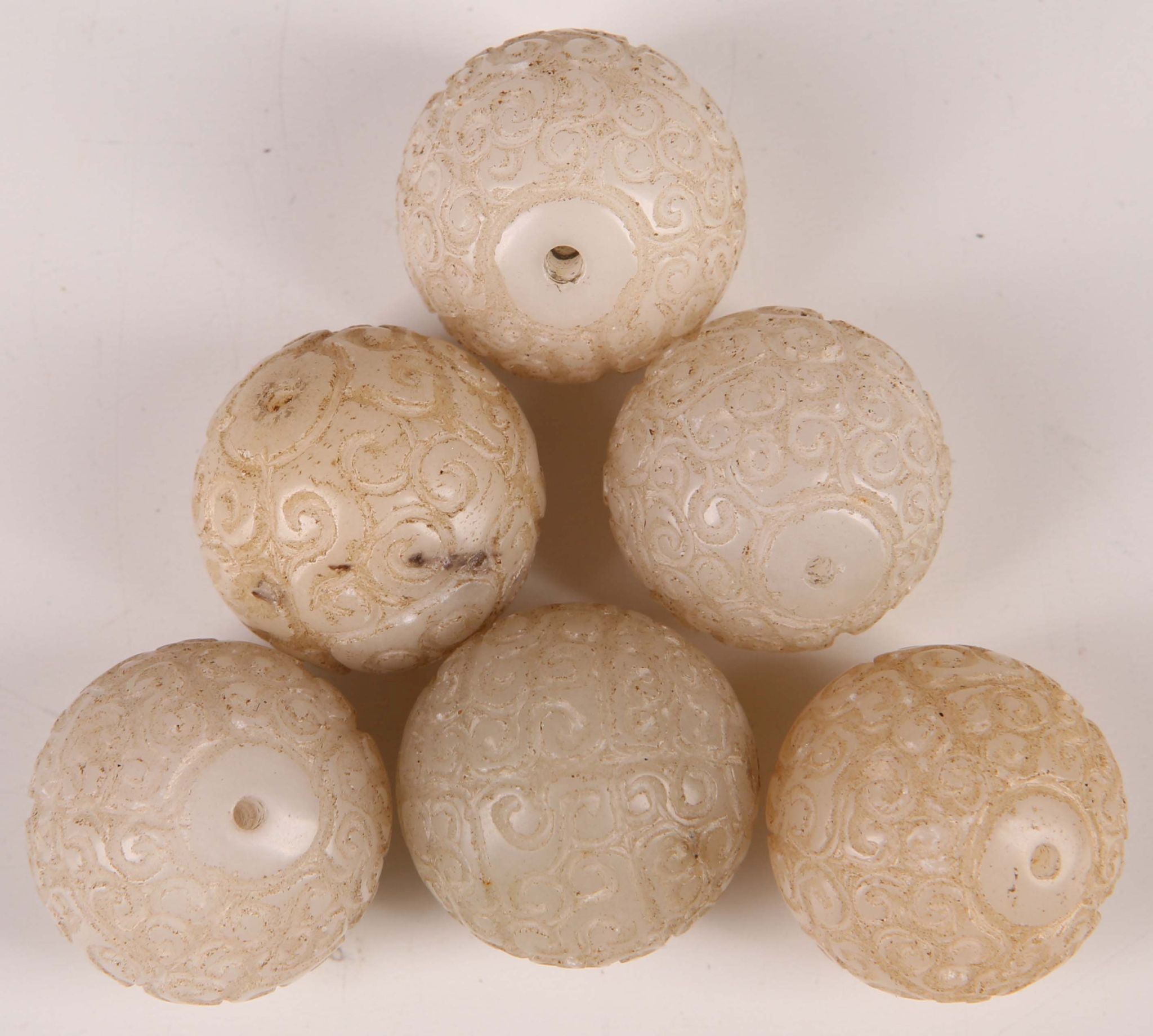 Chinese white jade beads, each with abstract carving, approx. 2.3cm dia. (6)
