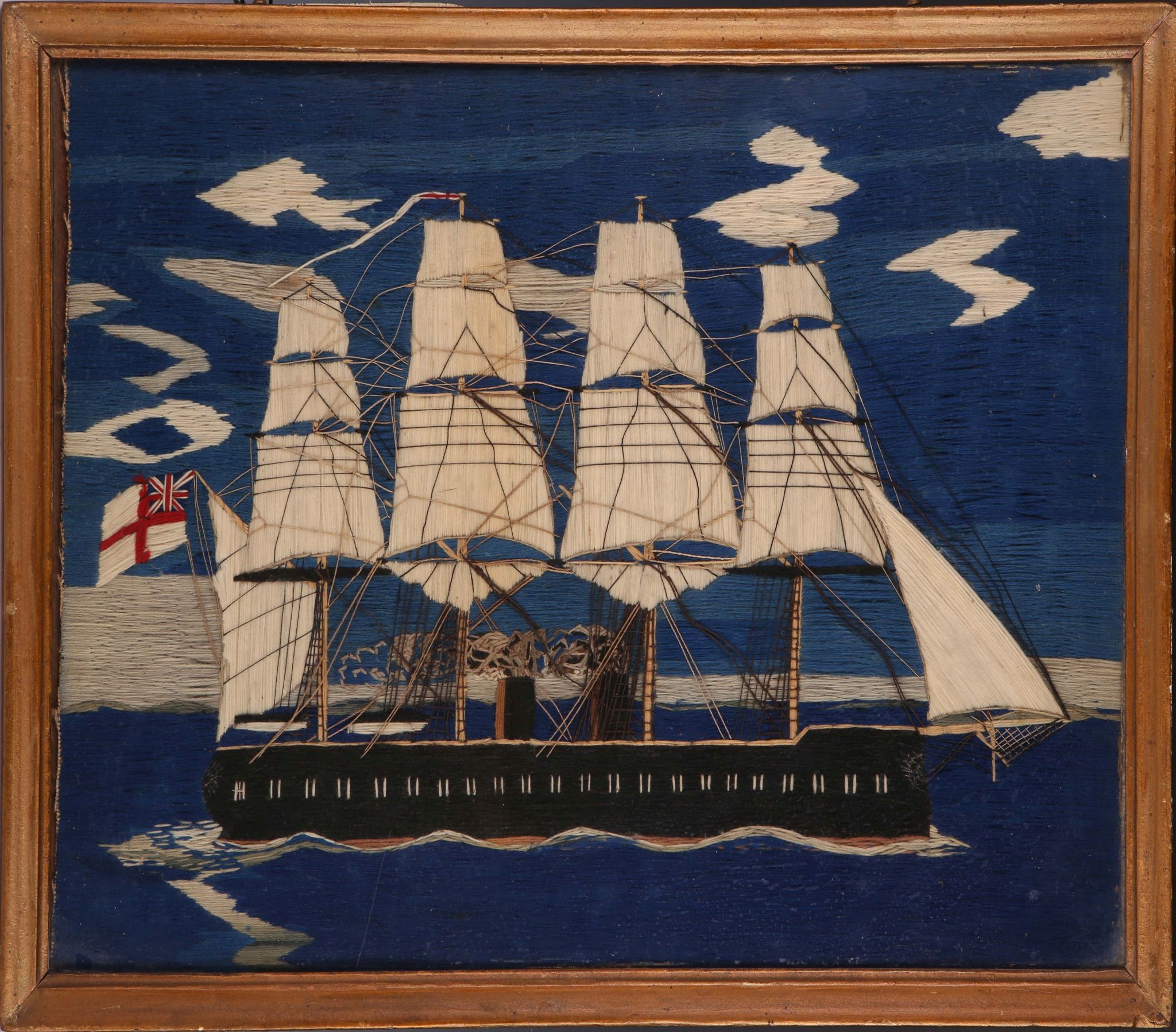 A Victorian sailor`s woolwork of four masted clipper in full sail, 33.5 x 50cm.