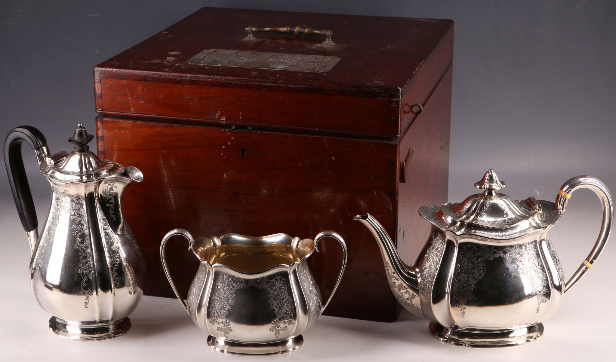 An Edwardian mahogany silver box, with four piece EPNS tea set of pot, hot water, milk and twin