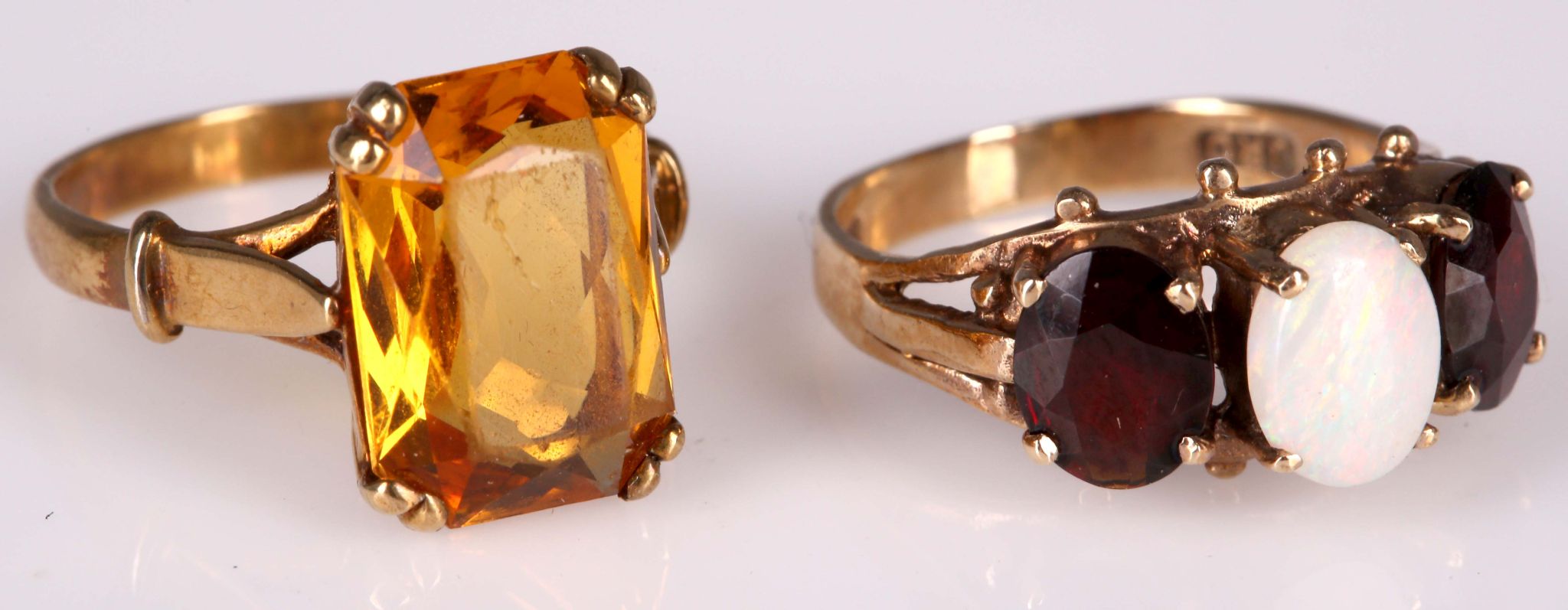 Two 9ct ladies dress rings; one set with central opal flanked by two garnets, sold together with a