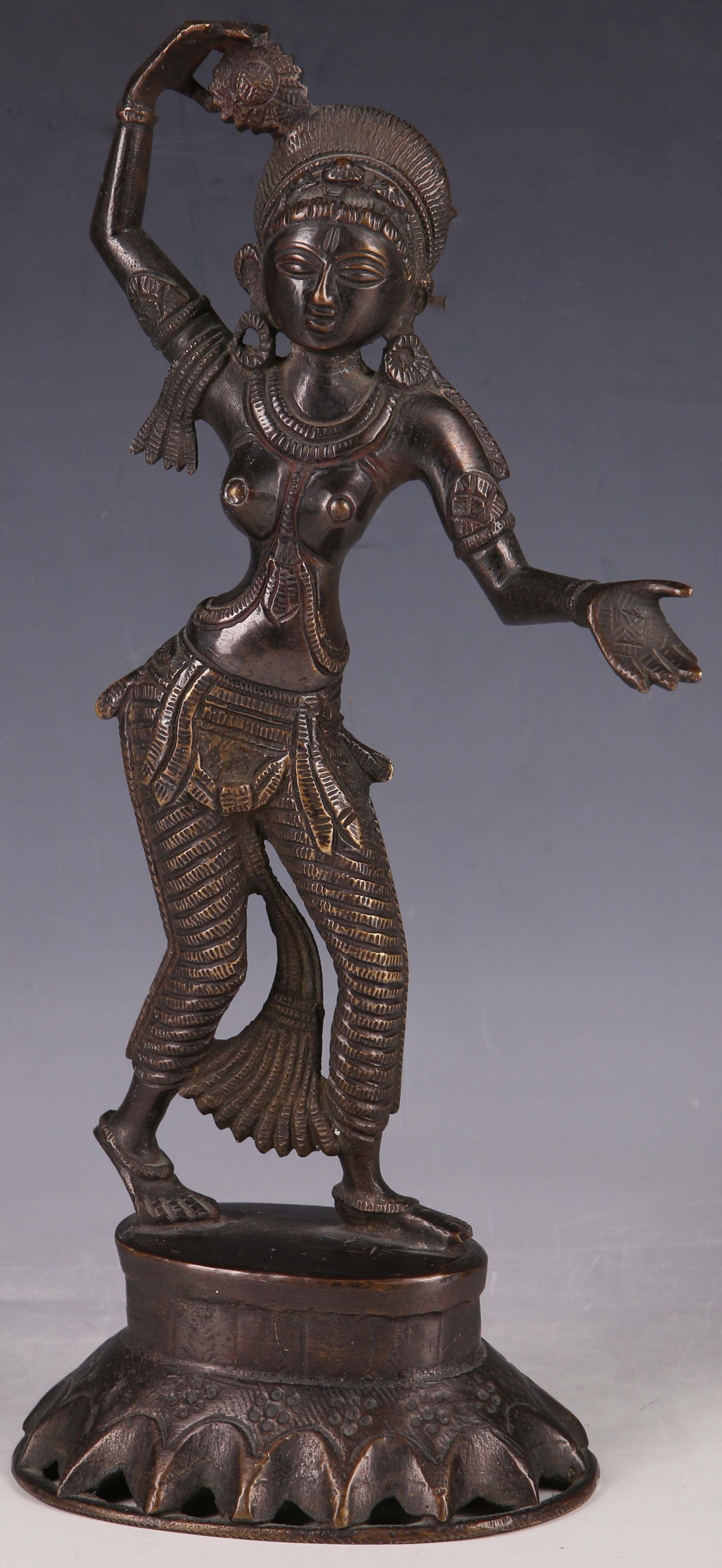 A 20th Century Indian bronzed statue of temple Goddess, raised on oval base.