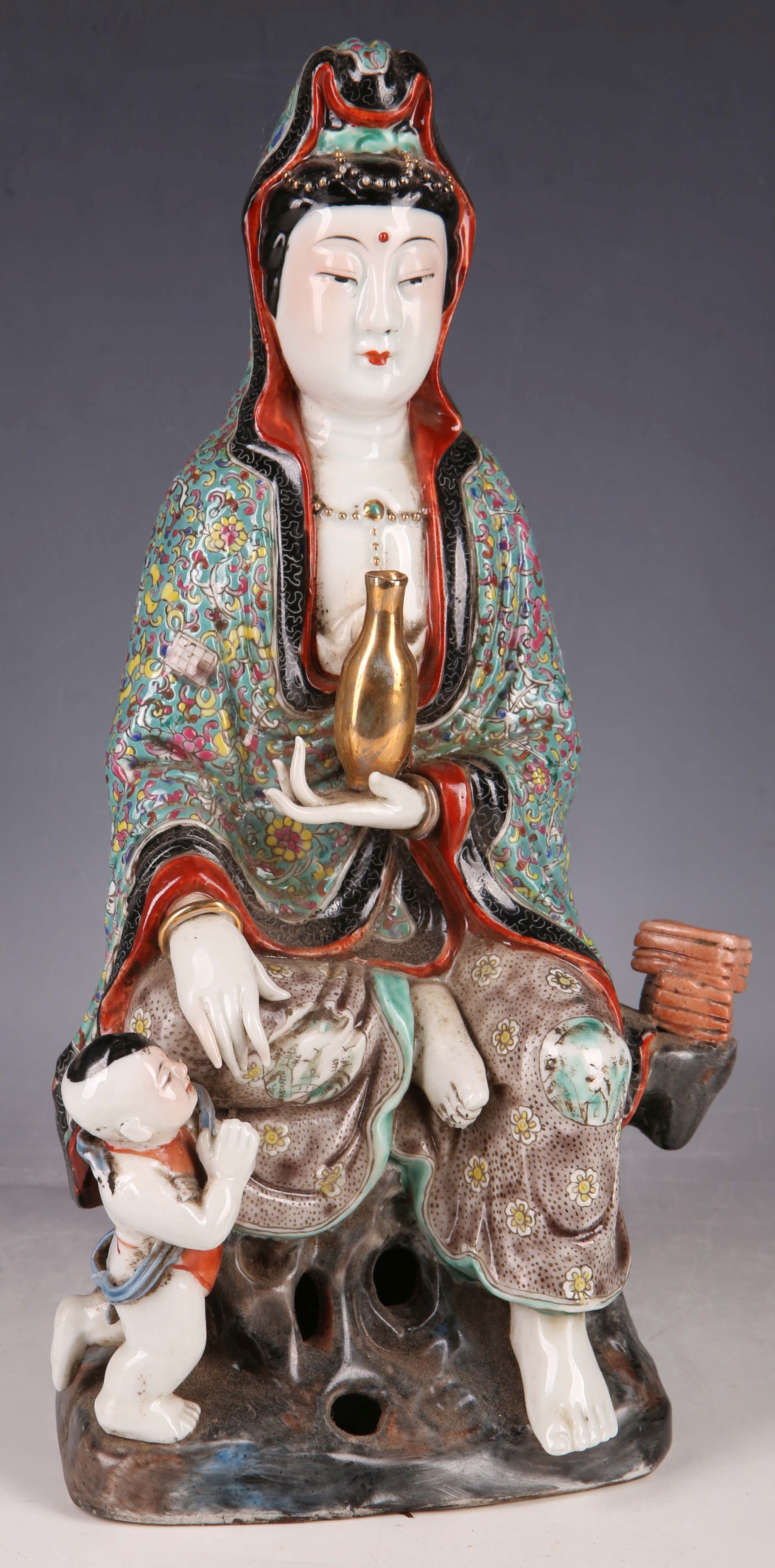 A Chinese study of Guanyin Goddess, multi-colour enamel robe, carrying a gilded vase, seated on a